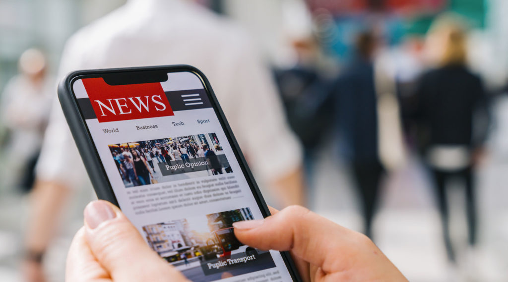 Person Reading News on Phone